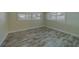 Bright bedroom showcasing light wood flooring, plantation shutters, and neutral wall color at 735 123Rd Ave, Treasure Island, FL 33706