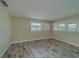 Cozy bedroom features modern shutter windows, neutral paint, and stylish wood-look floors at 735 123Rd Ave, Treasure Island, FL 33706