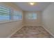 Bright bedroom boasts ample natural light and clean look with shuttered windows and stylish floors at 735 123Rd Ave, Treasure Island, FL 33706