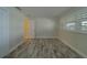 Bedroom with light wood flooring and plantation shutters at 735 123Rd Ave, Treasure Island, FL 33706