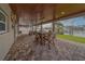 Spacious covered patio with wood ceiling, ceiling fans, and stone column accents at 735 123Rd Ave, Treasure Island, FL 33706