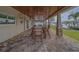 Covered outdoor patio with seating, ceiling fans, and outdoor dining area at 735 123Rd Ave, Treasure Island, FL 33706