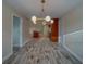 Bright dining area featuring a modern light fixture and wood-look tile flooring at 735 123Rd Ave, Treasure Island, FL 33706