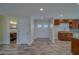 Bright entryway featuring wood-look tile flooring, white walls, and views of kitchen and bath at 735 123Rd Ave, Treasure Island, FL 33706