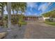 Charming single-story home with a paved driveway and well-maintained landscaping in a tranquil setting at 735 123Rd Ave, Treasure Island, FL 33706