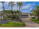 Inviting one-story home with a brick driveway, manicured lawn, and lovely landscaping at 735 123Rd Ave, Treasure Island, FL 33706