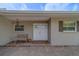 Welcoming front porch with a cozy bench, lantern, and neutral paint at 735 123Rd Ave, Treasure Island, FL 33706