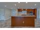 Open kitchen featuring a large island, wood cabinets and stainless steel appliances at 735 123Rd Ave, Treasure Island, FL 33706