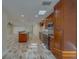 Open kitchen featuring wood cabinets, granite countertops, stainless steel appliances and wood-look tile flooring at 735 123Rd Ave, Treasure Island, FL 33706