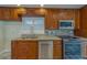 Kitchen with stainless steel appliances, granite countertops, and wood cabinets at 735 123Rd Ave, Treasure Island, FL 33706