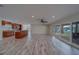 Open-concept living space with tile floors, sliding glass doors, and a breakfast bar at 735 123Rd Ave, Treasure Island, FL 33706