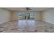 Spacious living room with wide plank flooring, ceiling fan, and glass doors to the outdoor patio at 735 123Rd Ave, Treasure Island, FL 33706