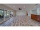 Bright open-concept living room with tile floors, sliding glass doors, and breakfast bar at 735 123Rd Ave, Treasure Island, FL 33706