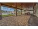 Expansive covered patio featuring brick pavers and ceiling fans, perfect for outdoor entertaining with scenic waterfront views at 735 123Rd Ave, Treasure Island, FL 33706