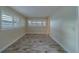 Bright room with wood look flooring, plantation shutters, and neutral paint at 735 123Rd Ave, Treasure Island, FL 33706