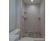 Modern shower design with marble-look tiling, mosaic flooring, and built-in shelving at 735 123Rd Ave, Treasure Island, FL 33706