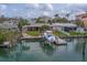 Waterfront home with a private boat dock, lush landscaping, and stunning views of the water at 735 123Rd Ave, Treasure Island, FL 33706