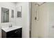 Bathroom with a shower, sink, and mirror, providing functionality and a clean aesthetic at 7821 Niagara Ave # 2102, Tampa, FL 33617
