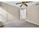 Bedroom features carpet floors, a ceiling fan, and a view of another room at 7821 Niagara Ave # 2102, Tampa, FL 33617