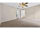Spacious bedroom with neutral carpet, ceiling fan, and access to the bathroom and closet at 7821 Niagara Ave # 2102, Tampa, FL 33617
