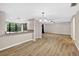 Dining room with wood-look floors, granite breakfast bar, and view into living area at 7821 Niagara Ave # 2102, Tampa, FL 33617