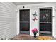 Close-up of front doors with decorative touches and a welcoming flower arrangement at the entrance at 7821 Niagara Ave # 2102, Tampa, FL 33617