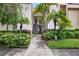 Charming condo featuring a well-kept exterior with lush landscaping and mature palm trees at 7821 Niagara Ave # 2102, Tampa, FL 33617