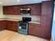 Well appointed kitchen with stainless appliances and cherry cabinets at 7821 Niagara Ave # 2102, Tampa, FL 33617