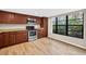 The kitchen is equipped with wood floors, wood cabinets, stainless steel appliances, and a large window at 7821 Niagara Ave # 2102, Tampa, FL 33617