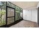 Enclosed lanai featuring tiled flooring and views of the surrounding greenery, perfect for relaxation at 7821 Niagara Ave # 2102, Tampa, FL 33617