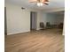 Bright living room features wood-look tile flooring, ceiling fan, and neutral paint at 7821 Niagara Ave # 2102, Tampa, FL 33617