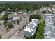 Aerial view of townhouses near a busy street, surrounded by lush greenery and offering convenient access to amenities at 803 Oak Bend Ln, Dunedin, FL 34698
