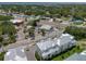 Scenic aerial view of townhouses near a busy street, surrounded by lush greenery, and near local shops at 803 Oak Bend Ln, Dunedin, FL 34698