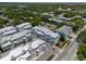 Wide aerial view showcases townhouses in a lush, well-maintained community offering serene living spaces and tree coverage at 803 Oak Bend Ln, Dunedin, FL 34698