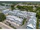 Expansive aerial view of townhouses surrounded by lush greenery in a well-maintained community near the bay at 803 Oak Bend Ln, Dunedin, FL 34698