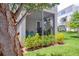 Relaxing screened porch with view to green, grassy lawn at 803 Oak Bend Ln, Dunedin, FL 34698