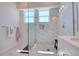 Shower featuring marble tiling and a glass enclosure at 803 Oak Bend Ln, Dunedin, FL 34698