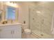 Bright bathroom featuring modern tile, a glass shower and a vanity at 803 Oak Bend Ln, Dunedin, FL 34698