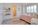 Bright bedroom features wood floors, shelves, and an ensuite bathroom at 803 Oak Bend Ln, Dunedin, FL 34698