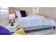 Comfortable bedroom with white quilted bedding and wood flooring at 803 Oak Bend Ln, Dunedin, FL 34698