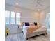 Bright bedroom with a gray bed and modern windows with white shutters at 803 Oak Bend Ln, Dunedin, FL 34698