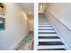 Bright entryway with staircase, wood floors, and white walls at 803 Oak Bend Ln, Dunedin, FL 34698