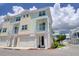 Beautiful two-story townhouse showcases a balcony and a two-car garage enhancing the property's curb appeal at 803 Oak Bend Ln, Dunedin, FL 34698