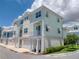 Charming two-story townhouse with a quaint balcony, manicured lawn, and a two-car garage at 803 Oak Bend Ln, Dunedin, FL 34698