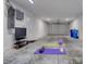Garage set up for fitness, with a yoga mat, exercise ball, and TV, providing a convenient workout space at 803 Oak Bend Ln, Dunedin, FL 34698