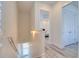 Upstairs hallway with view into bedroom, featuring white walls, doors, and light wood-look flooring at 803 Oak Bend Ln, Dunedin, FL 34698