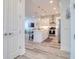 Open-concept living area showcases the modern kitchen with white cabinetry and stainless steel appliances at 803 Oak Bend Ln, Dunedin, FL 34698