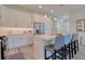Bright kitchen features quartz counters, stainless steel appliances, an island with seating, and modern lighting at 803 Oak Bend Ln, Dunedin, FL 34698
