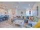 Open concept living room with a large sectional sofa and view into the kitchen at 803 Oak Bend Ln, Dunedin, FL 34698