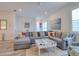 Spacious living room with a gray sectional sofa, patterned pillows, and art on the wall at 803 Oak Bend Ln, Dunedin, FL 34698